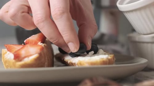 Woman or Girl Decorate Croissants with Soft Blueberry Cheese