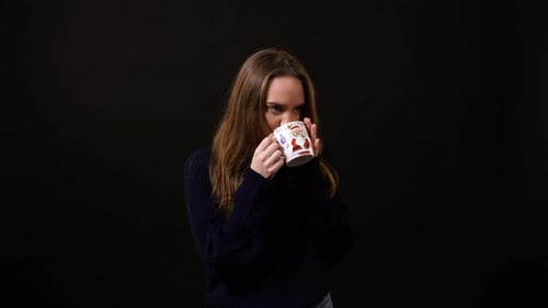 Smiling Woman Drinking from Christmas Mug