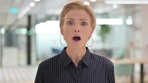 Woman Reacts with Surprise in an Office Environment