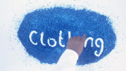 Hand Writes Clothing with Blue Particles