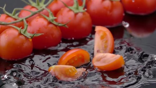 Slices of Ripe Tomato Falls on the Table