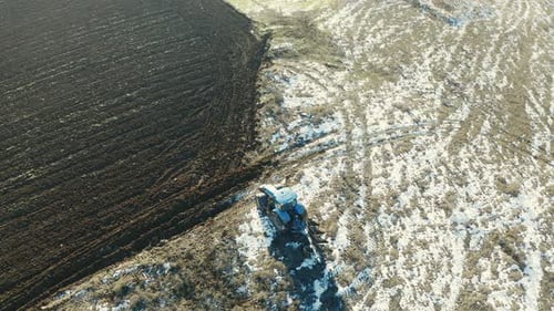 plowing field in winter