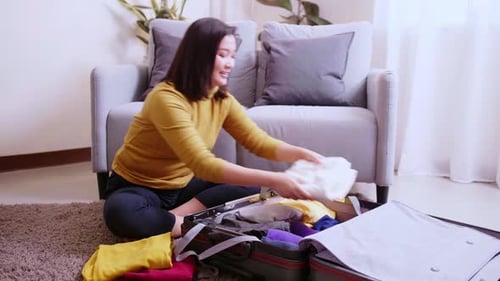 Woman Packing Luggage for a Travel Trip