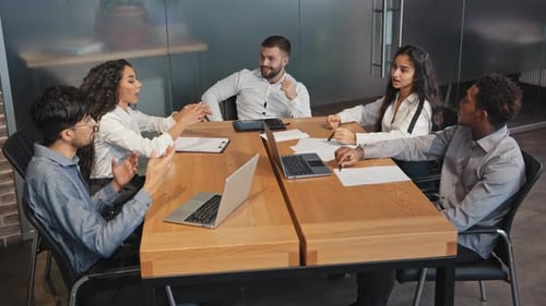 Young Adults Meeting at Conference Table