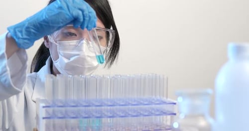 Scientist Inspects Blue Liquid in Test Tube