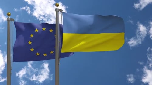 European Union and Ukraine Flags Waving on Poles