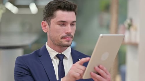 Handsome Man in Suit Uses Digital Tablet