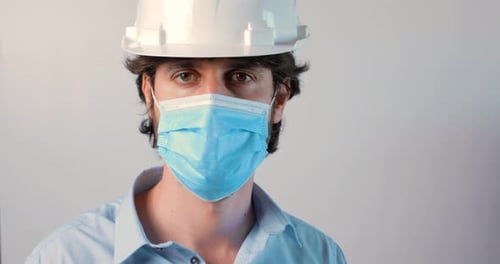 Adult Wearing Hard Hat and Face Mask
