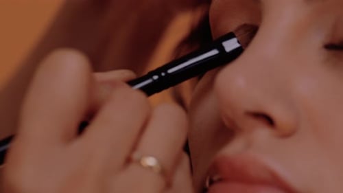 Makeup Artist Applying Eye Makeup with Brush