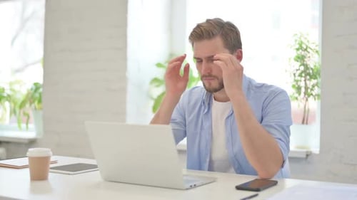 Man Working at Laptop Massages Temples