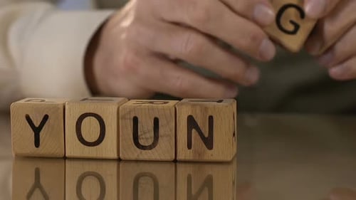 Young, Senior Man Making Word of Wooden Cubes, Memories, Desire to Be Younger