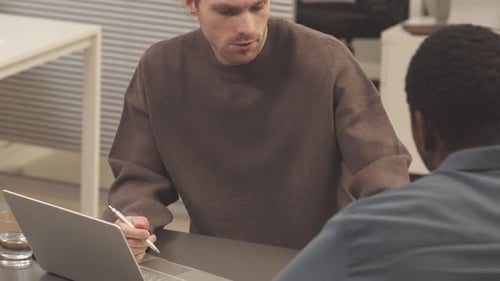 Team Discusses Graphs At The Office