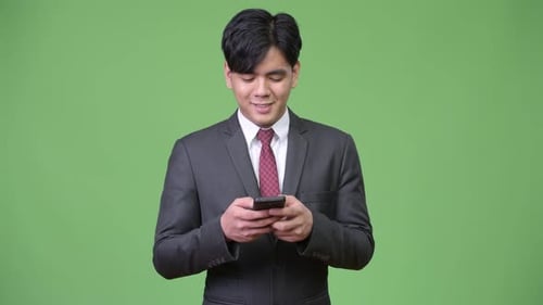 Young Adult Uses Smartphone in Studio Setting