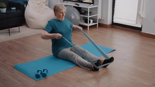 Senior Woman Exercising with Resistance Band at Home