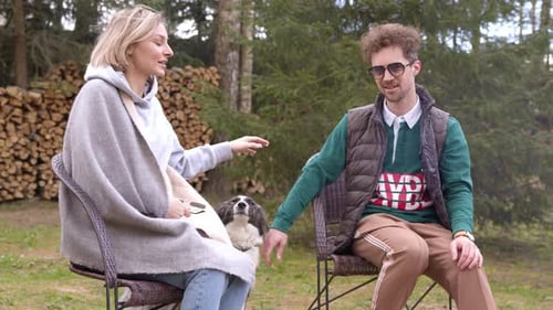 Young Couple Petting Dog in a Rural Setting