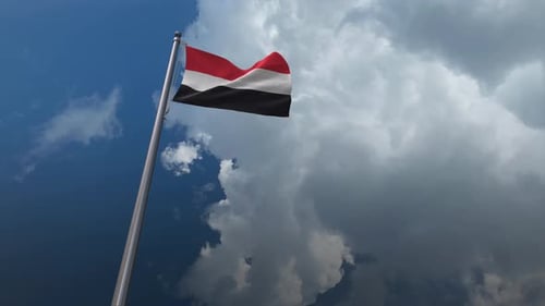 Yemen Flag Waving Against Dramatic Cloudy Sky