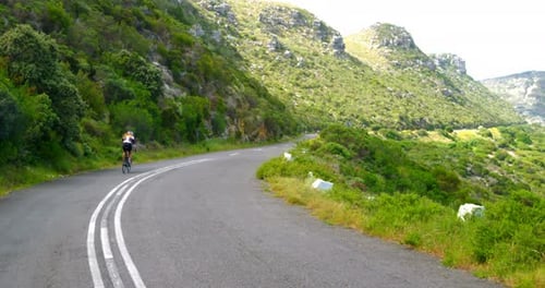 Female cyclist cycling on a countryside road