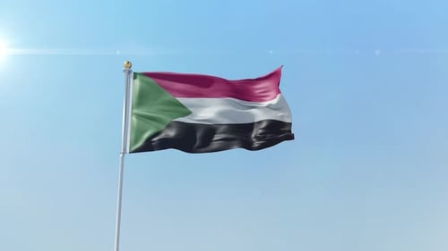 Waving Flag of Sudan on Blue Sky