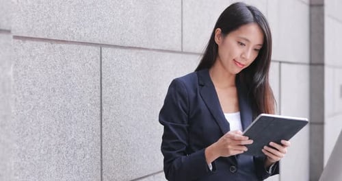 Woman Using Tablet in Urban Environment
