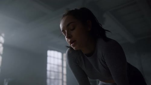 Sportswoman Standing in Gym After Training