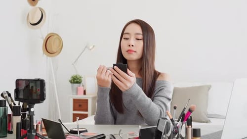 Young Woman Applying Makeup for Beauty Blog