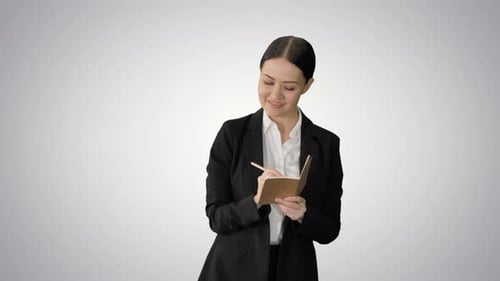 Businesswoman Taking Notes in Notebook