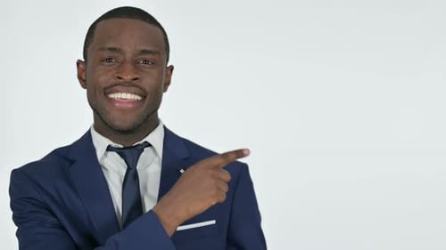 African Businessman Pointing at Product with Finger, White Background