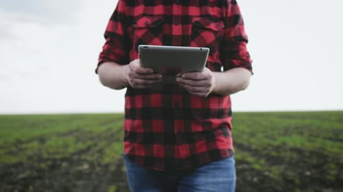 Farmer Uses Tablet in the Field