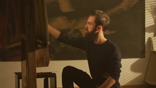 Bearded Artist Painting Portrait in Studio