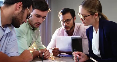 Team Analyzing Data in Office Meeting