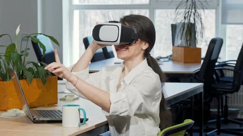 Woman Uses Virtual Reality Headset in Bright Office