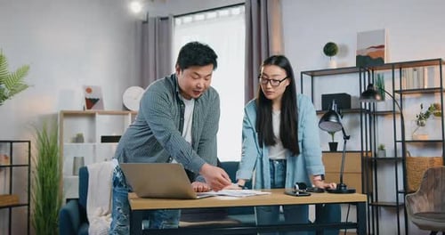 Modern Asian Colleagues Standing Near Workplace in Home Office