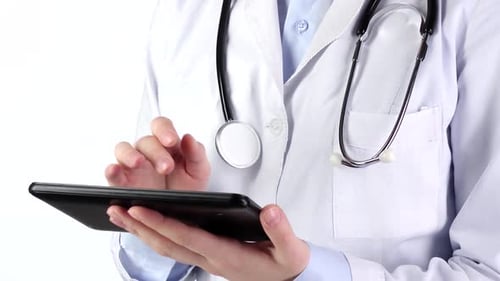 Doctor Standing and Holding Tablet Compute, Wearing Stethoscope, on White