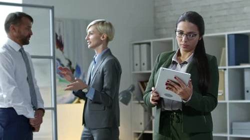 Businesswoman Using Tablet during Office Workday