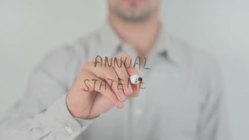 Writing Annual Statement on Clear Surface