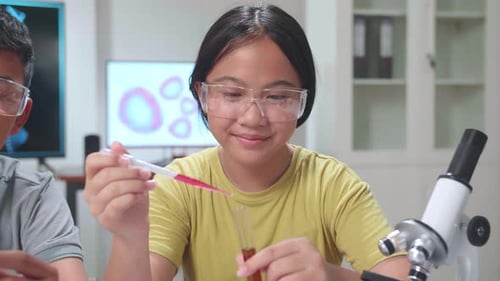 Boy And Girl Learning Science Experiment In Laboratory At Classroom. Study With Scientific Equipment