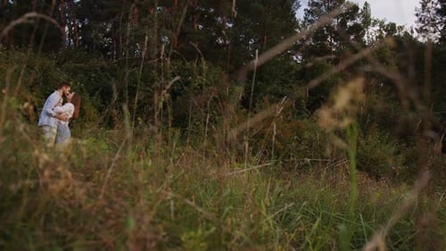 A Beautiful Girl and Boy Hugging in a Park