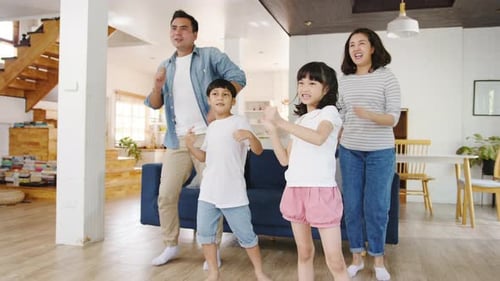 Happy Family Dancing Together at Home