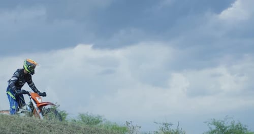 Motocross biker riding on a cloudy day