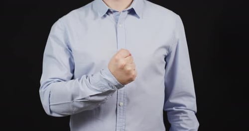 Torso shaking fist in close up