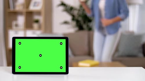 Tablet Computer with Green Screen on Table at Home 139