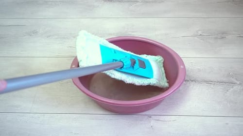 Mop Soaking in Bucket of Water for Cleaning