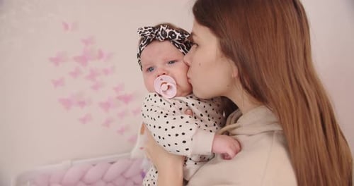 Loving Mother Holding Her Infant Child