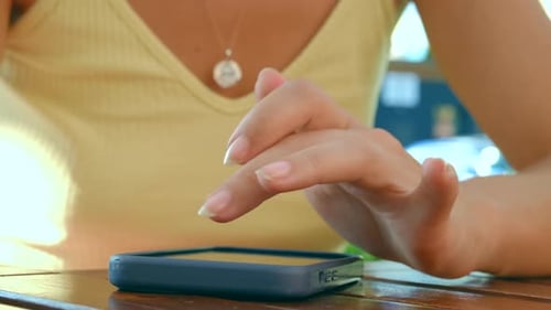 Woman Using a Smartphone on a Table