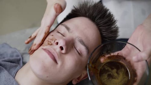 Man Getting a Facial Scrub Treatment at Spa