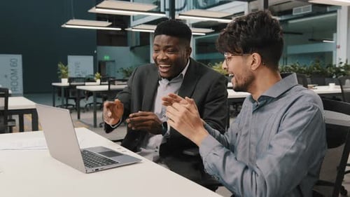 Two Men Celebrating Success at Office Computer