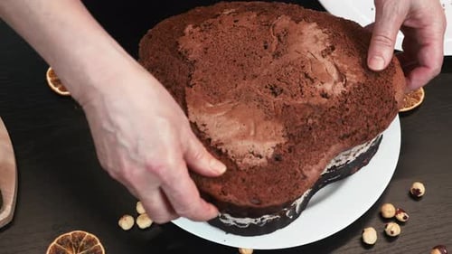 Assembling Chocolate Hazelnut Cake on Kitchen Table