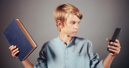 Teen Holds Book and Cell Phone in Studio