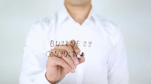 Man Writes Business Consultation on Glass Surface