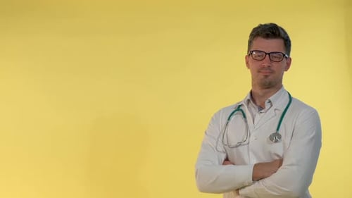 Cheerful Young Doctor in Lab Coat Nodding His Head Showing That He is Agree with Something